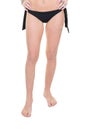 Beautiful young woman slim legs in black swimwear panties on white background Royalty Free Stock Photo