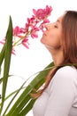 Beautiful young woman smelling orchid flower Royalty Free Stock Photo