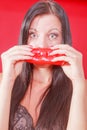 Beautiful young woman smelling red pepper Royalty Free Stock Photo