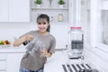 Beautiful woman pouring fresh water in kitchen Royalty Free Stock Photo