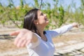 Beautiful young woman smiling cheerful with open arms and eyes closed relaxing and enjoying sunbathe in a sunny day of spring Royalty Free Stock Photo