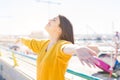 Beautiful young woman smiling with closed eyes and open arms enjoying the sunlight on a sunny day. Happy sunbathe Royalty Free Stock Photo