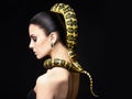 Beautiful young woman with Snake on her head