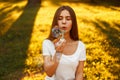 Beautiful young woman with soap bubbles at sunset in the park. Royalty Free Stock Photo