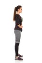 Beautiful Young Woman In Sports Clothes Is Standing With Hand On Hip. Side View. Royalty Free Stock Photo