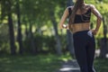 Beautiful young woman in sportswear Jogging in the Park with