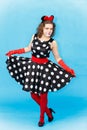 Beautiful young woman in spotted dress dancing in studio Royalty Free Stock Photo