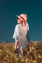 Beautiful young woman standing in field in summer Royalty Free Stock Photo