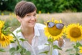 A beautiful young woman is standing in a field of sunflowers in the summer. Royalty Free Stock Photo