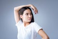 Beautiful young woman standing with her arm resting on the head Royalty Free Stock Photo