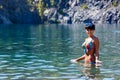 Beautiful young woman standing in a mountain lake Royalty Free Stock Photo