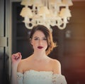 Beautiful young woman standing near the door in the light luxury Royalty Free Stock Photo
