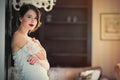 beautiful young woman standing near the door in the luxury Royalty Free Stock Photo