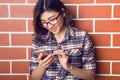 Beautiful young woman standing at the street and using her mobile phone Royalty Free Stock Photo