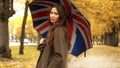 Beautiful young woman standing with umbrella on autumn alley on a rainy day Royalty Free Stock Photo