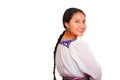 Beautiful young woman standing wearing traditional andean blouse and red necklace, turning head looking towards camera Royalty Free Stock Photo