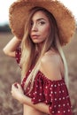 Beautiful and young woman straw hat in summer in field. Concept village girl nature. Emotions tenderness, elegance Royalty Free Stock Photo