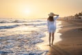 Beautiful young woman with straw hat in white dress on the sea Royalty Free Stock Photo