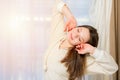 Beautiful young woman stretching in bed after waking up Royalty Free Stock Photo