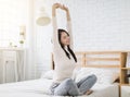 Beautiful young woman stretching and waking up in the bedroom Royalty Free Stock Photo