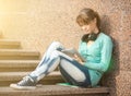 Beautiful young woman student with note pad and headphones. Outdoor student. Royalty Free Stock Photo