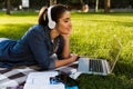 Beautiful young woman student in the park using laptop computer. Royalty Free Stock Photo