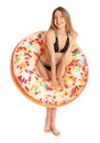 Beautiful young woman in stylish bikini with doughnut inflatable ring on white Royalty Free Stock Photo
