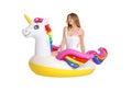 Beautiful young woman in stylish bikini with  unicorn inflatable ring Royalty Free Stock Photo