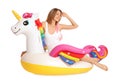 Beautiful young woman in stylish bikini with  unicorn inflatable ring Royalty Free Stock Photo