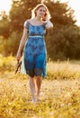 Beautiful young woman on summer dress standing in field Royalty Free Stock Photo