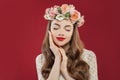 Beautiful young woman with summer pink flowers, long permed curly hair and fashion makeup