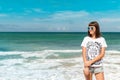Beautiful young woman in sunglasses posing on the beach of a tropical island of Bali, Indonesia. Royalty Free Stock Photo
