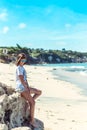 Beautiful young woman in sunglasses posing on the beach of a tropical island of Bali, Indonesia. Royalty Free Stock Photo