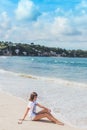 Beautiful young woman in sunglasses posing on the beach of a tropical island of Bali, Indonesia. Royalty Free Stock Photo