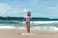 Beautiful young woman in sunglasses posing on the beach of a tropical island of Bali, Indonesia. Royalty Free Stock Photo