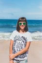 Beautiful young woman in sunglasses posing on the beach of a tropical island of Bali, Indonesia. Royalty Free Stock Photo