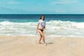 Beautiful young woman in sunglasses posing on the beach of a tropical island of Bali, Indonesia. Royalty Free Stock Photo