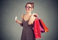 Beautiful young woman in sunglasses with shoppping bags and credit card