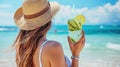 Beautiful young woman in sunglasses straw hat holds lemonade or tropical fresh citrus cocktail, beach exotic vacation Royalty Free Stock Photo