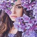 Beautiful young woman surrounded by flowers