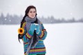 Beautiful young woman in a sweater on a winter walk with a cup o Royalty Free Stock Photo
