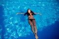 Beautiful young woman on the swimming pool. Body, black swimsuit, summer.