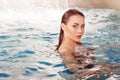 Beautiful young woman swimming in the pool, portrait. Attractive brunette girl Royalty Free Stock Photo