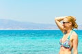 Beautiful young woman in swimsuit, relaxing on a tropical sunny beach Royalty Free Stock Photo