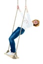 Beautiful young woman on a swing against white studio. Royalty Free Stock Photo