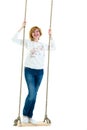 Beautiful young woman on a swing against white studio background. Royalty Free Stock Photo