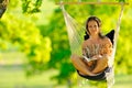 Beautiful young woman swinging outdoor