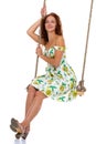 Beautiful young woman swinging on rope swing Royalty Free Stock Photo