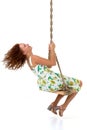 Beautiful young woman swinging on rope swing Royalty Free Stock Photo