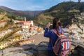 Beautiful young woman take photo of Vernazza looking at stunning panoramic view of Vernazza village in the Cinque Terre